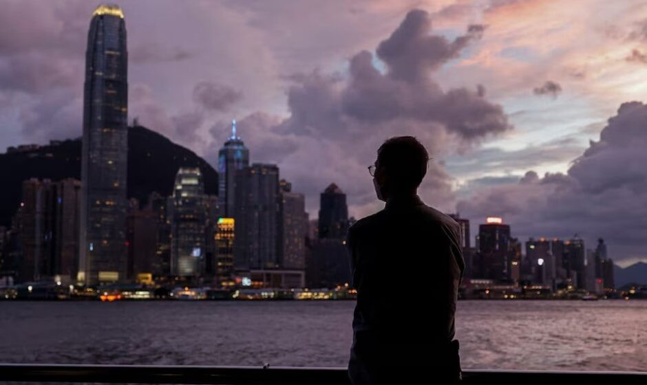 a man stands in front of victoria harbour with the central financial district in the background as typhoon yagi approaches in hong kong china on september 5 2024 photo reuters