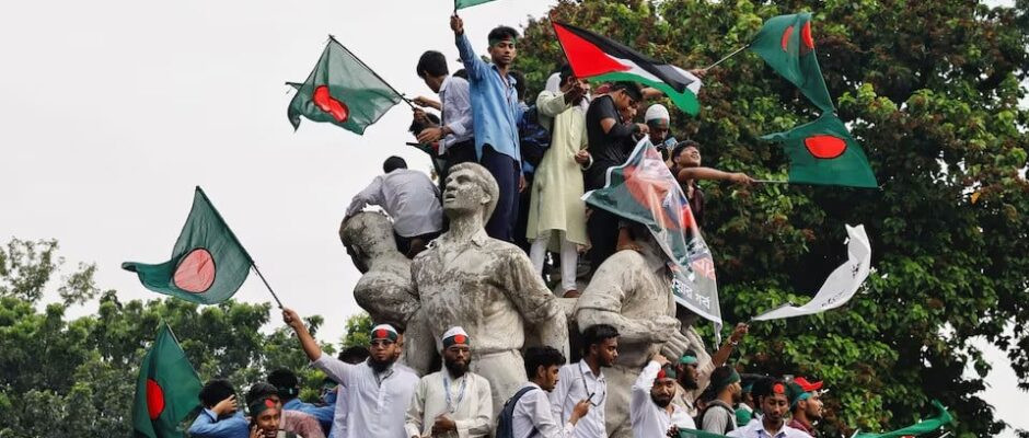 students against discrimination wave flags by standing on top of raju memorial sculpture as they join in a rally to mark one month of the end of awami league regime at the university of dhaka in dhaka bangladesh september 5 2024 photo reuters